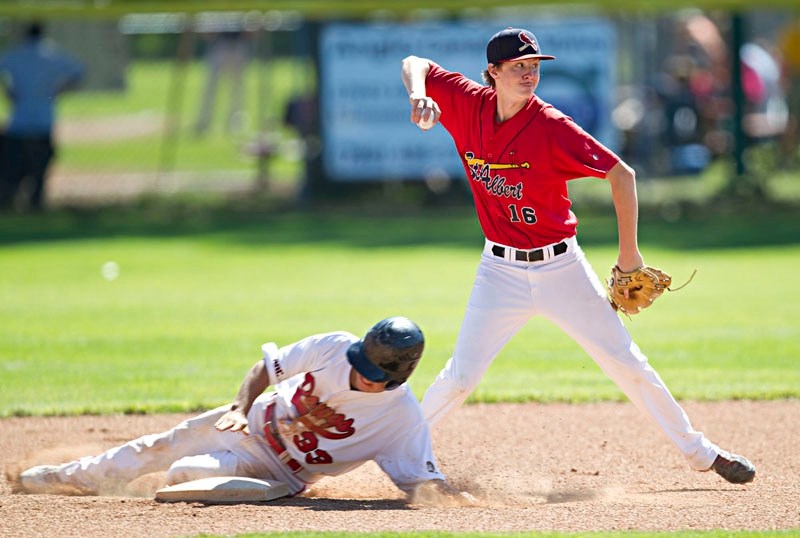 St. Albert Cardinals shortstop Tanner Karpinski turns the double play against Okotoks Red in Norwest midget AAA league action Sunday at Legion Memorial Park. The Cardinals
