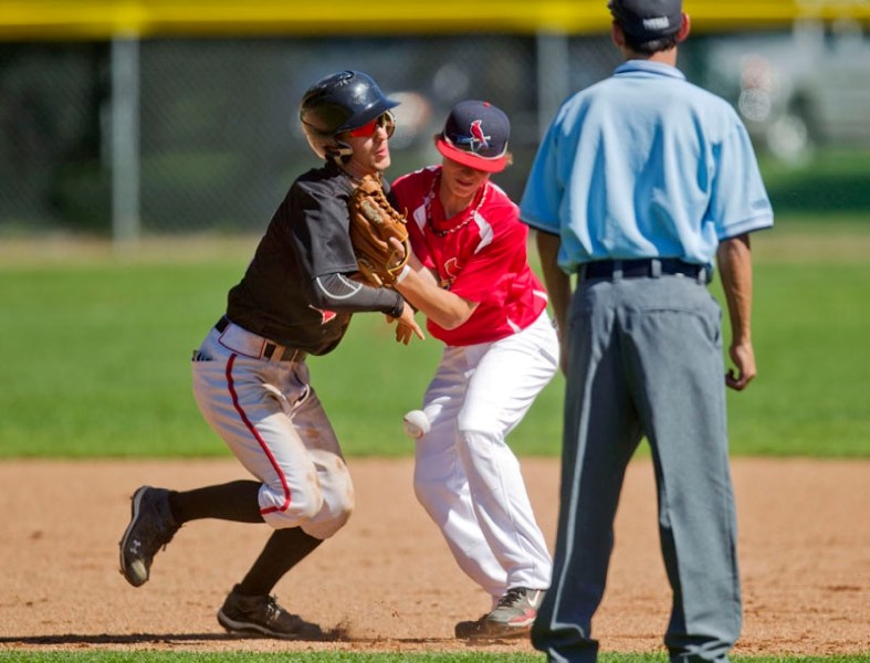 Foothills Black player Carson Wlad collides with St. Albert Cardinals&#8217; infielder Mat Brisson while making his way back to second base at the bantam AAA provincials
