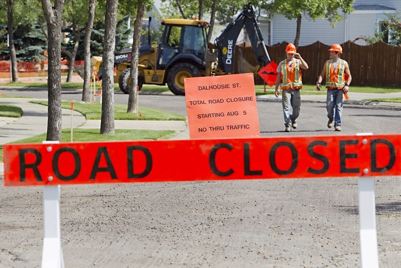 Labourers Mitch Hansen (left) and Dallas Ungurian walk past construction signs on Dalhousie Street