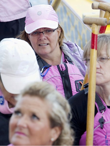 Breast cancer survivour Bernadette Giblin of St. Albert and teammates from Breast Friends listen to instructions as they load into a dragon boat at Louise McKinney Park on