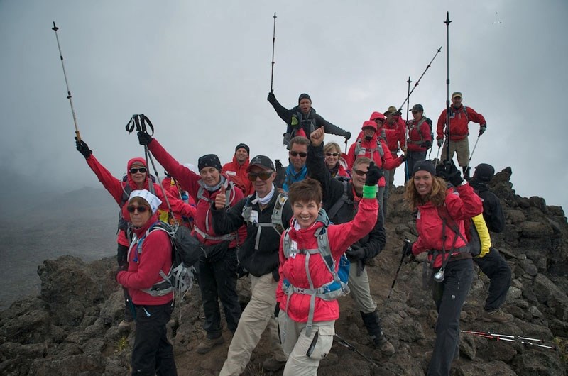 The Kilimanjaro Climb 2011 team raises their poles in celebration during their last practice hike at Mawenzi Tarn
