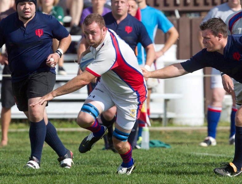 St. Albert power forward Dominik Jenni avoides a tackle against the Clansmen in Saturday&#8217;s premier division match at the St. Albert Rugby Football Club. St. Albert