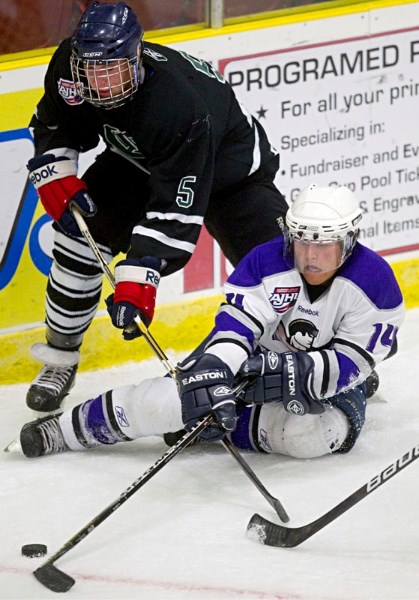 St. Albert Steel hopeful A.J. Yariwon tries to poke the puck away from a Sherwood Park Crusader in Friday&#8217;s exhibition at Performance Arena. The Steel lost 9-4.
