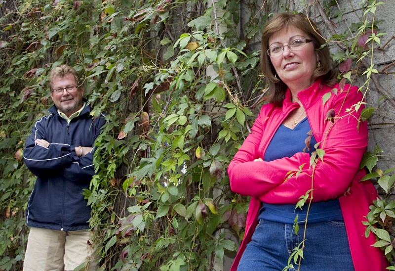 Colette and Bob Carlson stand amongst their Virginia creeper vines that covers the sound barrier between their Sturgeon area home and St. Albert Trail. Many residents in the