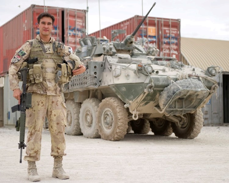 St. Albert resident Capt. Curtis Chow poses in front of a light armored vehicle at Kandahar Airfield in Afghanistan on Friday. He is second in command of the Force Protection 
