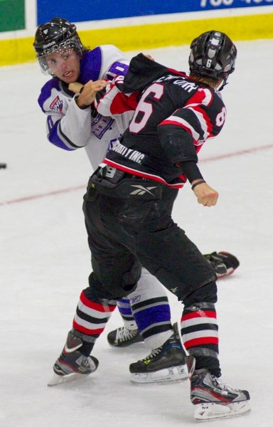 Craig Bokenfohr of the Camrose Kodiaks winds up to throw a punch at Reed Linaker of the St. Albert Steel during a second-period scrap in Tuesday&#8217;s exhibition at
