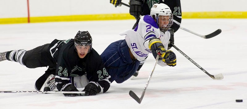 Liam McNamara of the St. Albert Steel takes a spill after a collision with Jessi Hilton of the Sherwood Park Crusaders during exhibition action last weekend at Performance