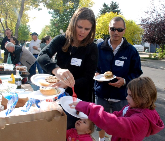 The Ma family load up on food at a block party on Piedmont Crescent Saturday afternoon. Pictured are mother Liza