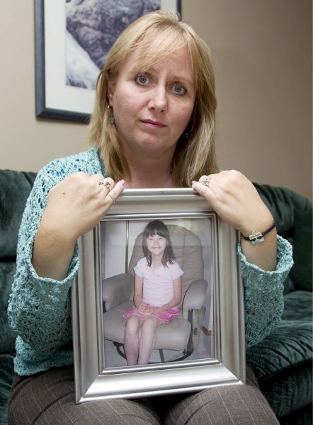 Velvet Martin of St. Albert holds a portrait of her daughter Samantha who died in 2006 of heart failure after being in foster care. Martin is asking the courts to force the
