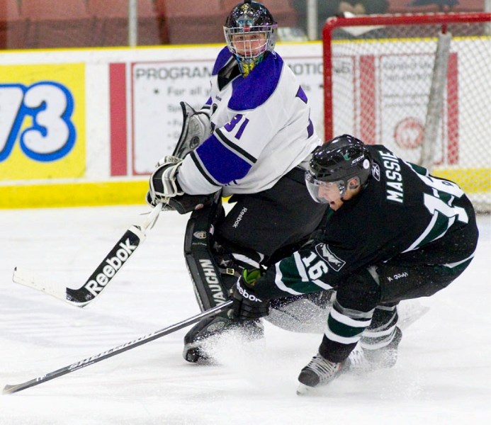 St. Albert Steel goalie Rhys Hadfield clears the puck way from Dillon Massie of the Sherwood Park Crusaders in the Steel&#8217;s home opener last weekend at Performance