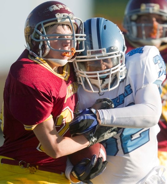 Running back Tyler Mah of the Paul Kane Blues protects the ball against the O&#8217;Leary Spartans in Tuesday&#8217;s high school junior game in St. Albert. The Blues whip