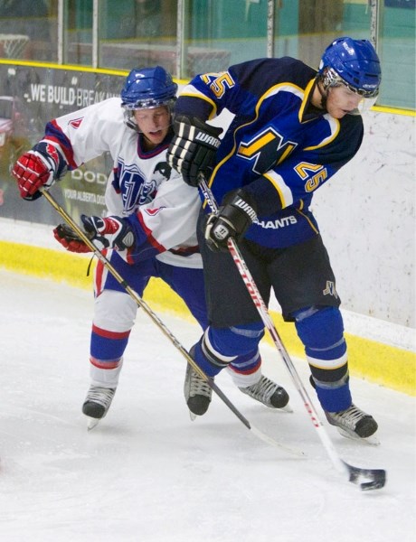 Dylan Kocur of the St. Albert Merchants controls the puck against Jorey McRae of the Morinville Jets in Friday&#8217;s junior B game at Akinsdale Arena. The Jets won 3-1. The 