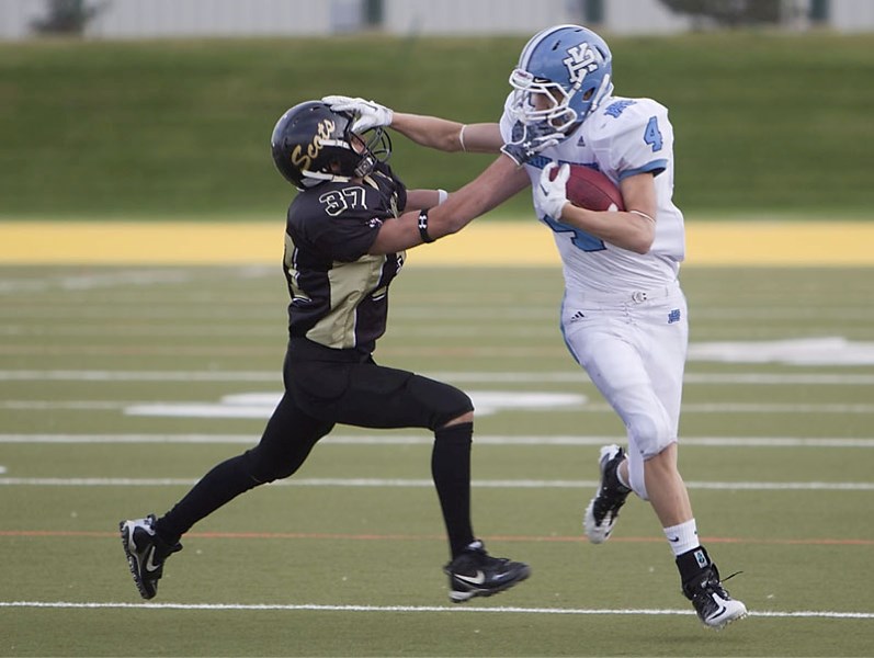Josh Wilkie of the Paul Kane Blues fends off a defender while running for a first down after catching a pass from Matteo Sestito in the third quarter of Thursday&#8217;s
