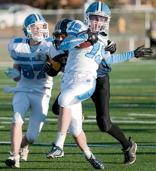 Eric Chaboyer of the Paul Kane Blues fights his way into the endzone after reeling in a pass from Cory Knott for a 15-yard TD in the second half of Tuesday&#8217;s 56-0