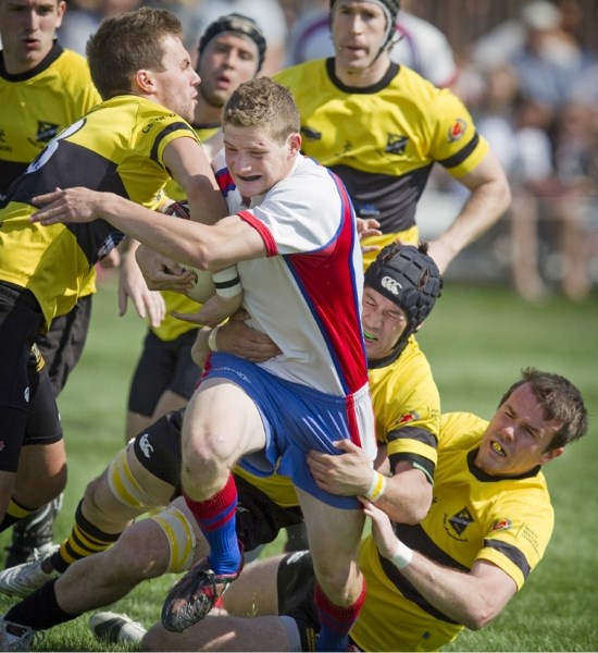 Duncan Maguire of the St. Albert firsts is gang tackled by a horde of swarming Calgary Hornets in Alberta Cup action May 28 in St. Albert. The Hornets won 27-14. Today at 4