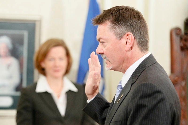 Local MLA Doug Horner takes an oath during the swearing-in of Premier Alison Redford&#8217;s new cabinet at Government House in Edmonton on Wednesday. Horner is