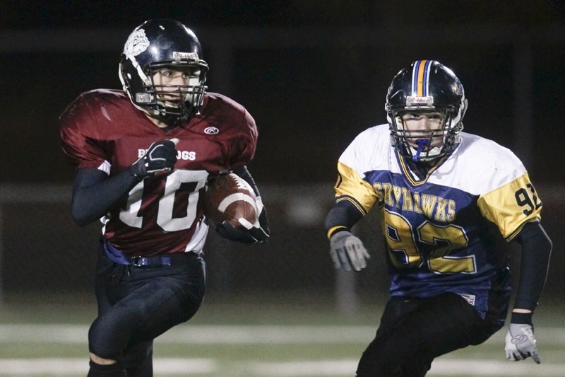 Andrew Johnson of the St. Albert Hawks chases after Tyler Thorsley of the Bellerose Dawgs in Tuesday&#8217;s metro Edmonton junior football game in St. Albert. Thorsley
