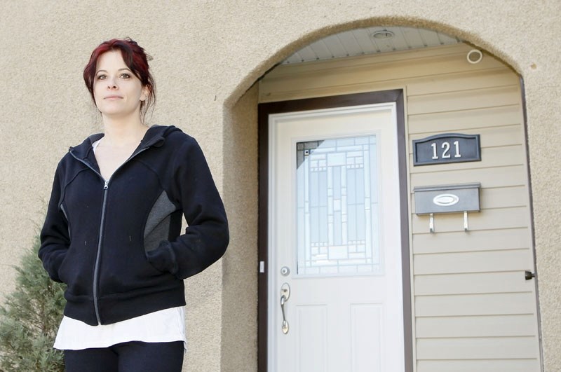 Kerry Sparrowe poses for a photo in front of her newly renovated house she moved into last weekend.