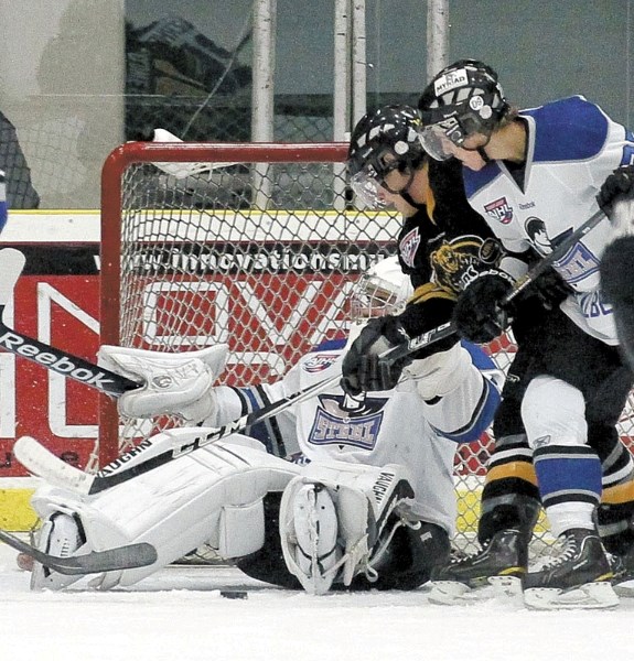 St. Albert Steel goalie Ty Swabb stops the puck during a scramble in front of the net in Friday&#8217;s 6-1 loss against the Olds Grizzlys at Performance Arena. Olds outshot