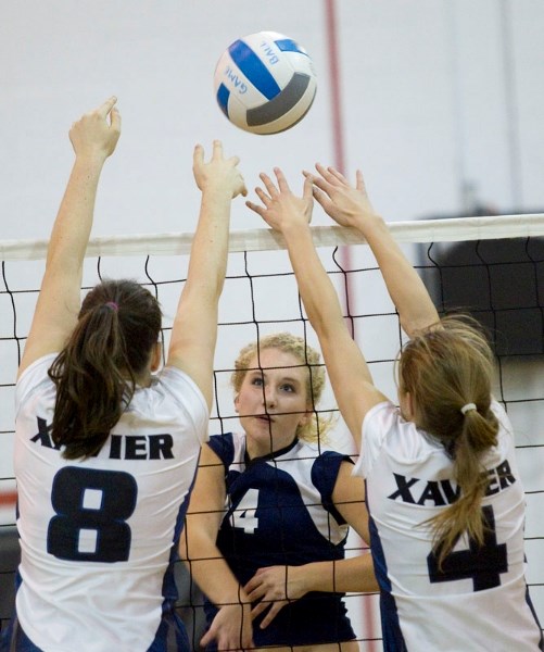 Emma Cunningham of the Paul Kane Blues sends the ball over top of the St. Francis Xavier blockers during Monday&#8217;s metro Edmonton premier conference match at Paul Kane