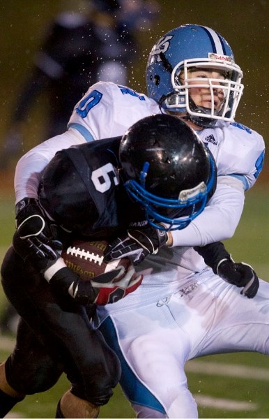 Paul Kane Blues&#8217; defensive end Patrick Turnbull wraps up a Beaumont Bandit in Wednesday&#8217;s premier conference semifinal in metro Edmonton high school junior