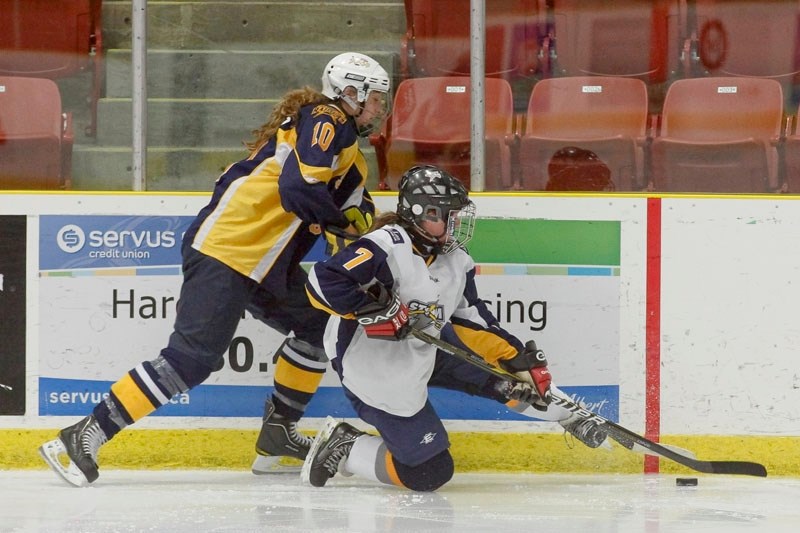 Denzelle Bourgeois of the St. Albert Slash tries to take the puck away from Maron Higson of the Grande Prairie Storm in Sunday&#8217;s game at Performance Arena. Bourgeois