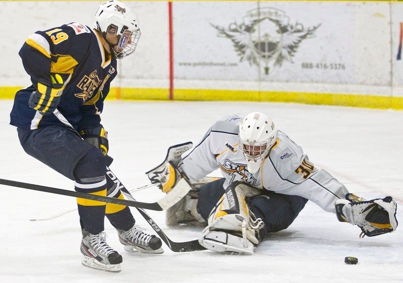 Kevin Miller of the St. Albert Raiders tries to slip the puck past Grande Prairie Storm goalie Connor Goudreau in Sunday&#8217;s midget AAA game at Akinsdale Arena. Miller