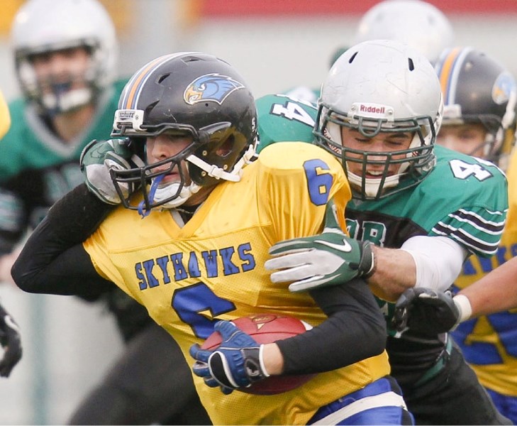 Aidan Panchyshyn of the Austin O&#8217;Brien Crusaders grabs the facemask of Nathan Pytel while trying to slow down the St. Albert High Skyhawk in Friday&#8217;s Carr