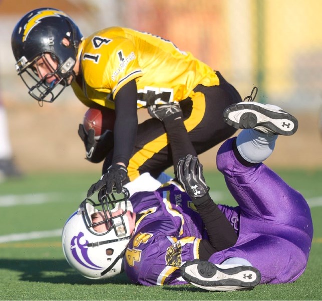 Joshua Coogan of the St. Albert Fury grabs the jersey of an Edmonton Chargers&#8217; player in Saturday&#8217;s tier I bantam semifinal in the Capital District Minor Football 