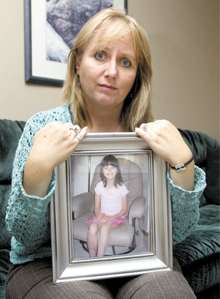 Velvet Martin of St. Albert holds a portrait of her daughter Samantha who died in 2006 of heart failure after being in foster care. An inquiry into Samantha&#8217;s death