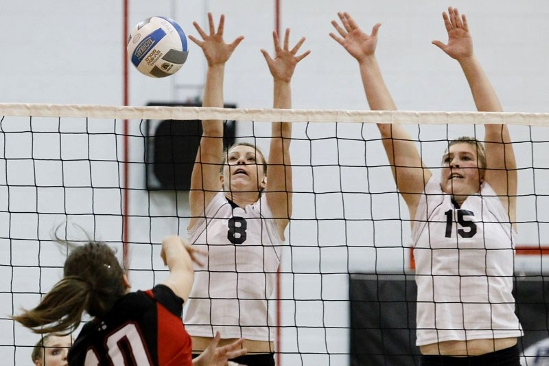 Larissa Kirdeikis (left) and Mackenzie Bender of the Paul Kane Blues defend the net in Wednesday&#8217;s playoff match against the Sturgeon Spirits at Paul Kane High School.
