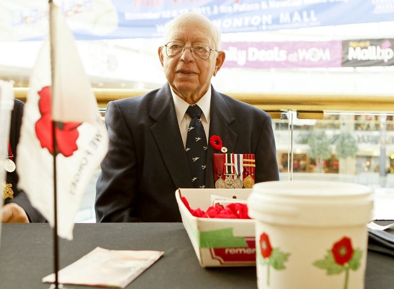 Canadian NATO veteran Bob Morgan helps out at the Legion poppy sale booth at West Edmonton Mall last week.