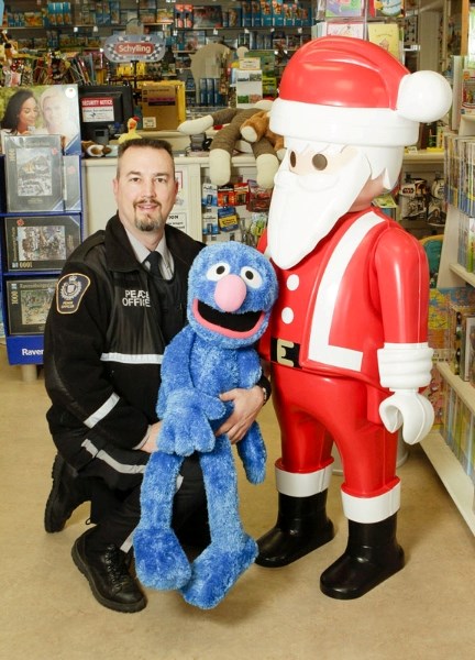 Municipal enforcement officer Garnet Melnyk visits a local toy store Thursday. Next week the city will launch its third annual Toys for Tickets campaign