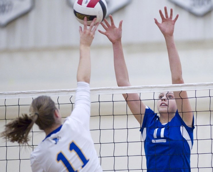 Paul Kane Blues&#8217; captain Whitney Follette eyes up a block against Renee Brown of the Bev Facey Falcons in Saturday&#8217;s premier conference final. The Blues swept