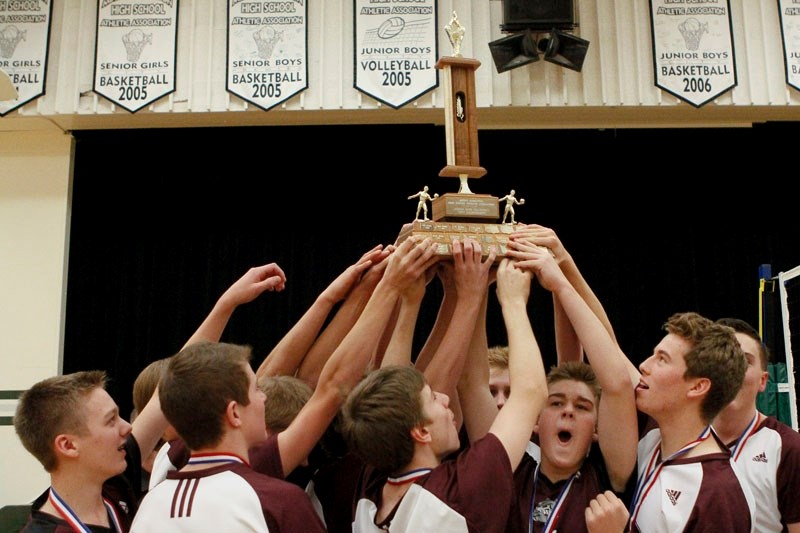 The Bellerose Bulldogs raise the championship trophy in celebration after sweeping the Archbishop MacDonald Marauders 25-17