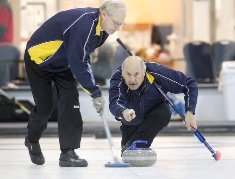John McKenzie releases a rock for sweeper Don Johnston with the Doug McLennan rink in Sunday&#8217;s A final against Mike Hutchings at the St. Albert OK Tire Men&#8217;s