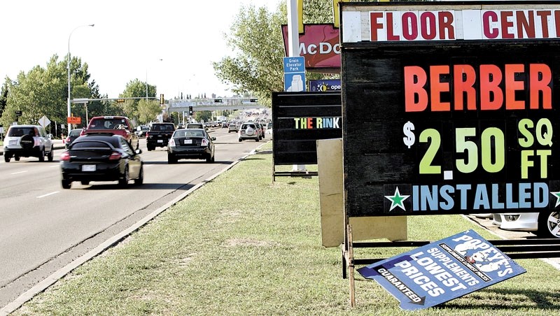 Council is considering raising portable sign fees by 400 per cent to reduce clutter on St. Albert Trail.