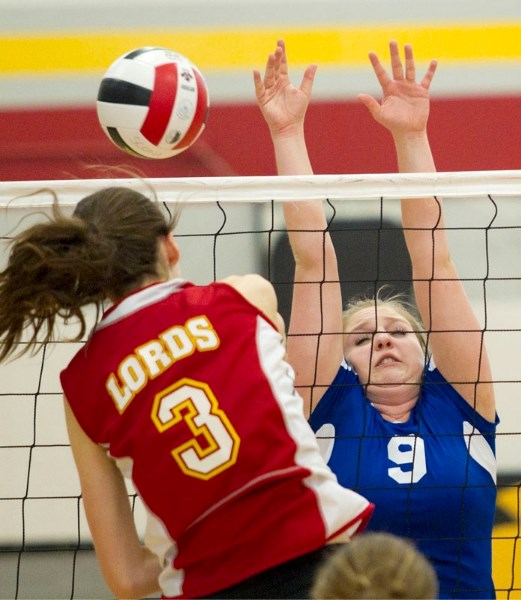 Karly Janssen of the Scona Lords powers the ball past Hailey Lutz of the Paul Kane Blues in Saturday&#8217;s semifinal at the 4A provincial volleyball tournament at