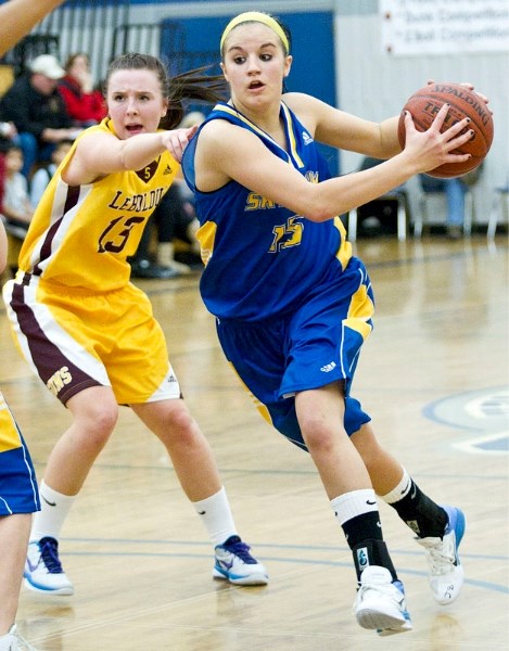 Kendall Lydon of the St. Albert Skyhawks drives past Megan Wilson of the Dr. Martin LeBoldus Golden Suns of Regina in Saturday&#8217;s final at the 14th annual Mike Dea