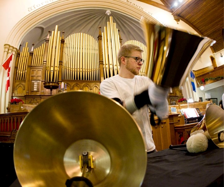 Edward Davies plays the bass bell for the University of Alberta Faculty of Education Handbell Ringers at the First Presbyterian Church in Edmonton. The Handbell Ringers will
