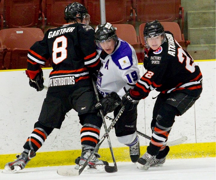 Mitch Loose of the St. Albert Steel is trapped between Mitchell Gartner and Josh Atkinson of the Lloydminster Bobcats in Wednesday&#8217;s AJHL game at Performance Arena. The 