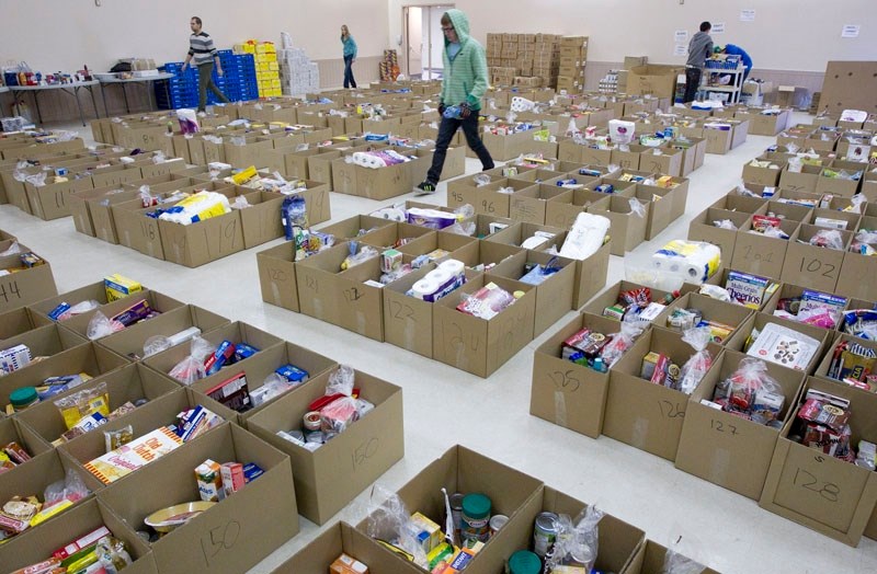 Volunteers sort and pack food hampers at the Kinsmen Banquet Centre as the Kinettes prepare to deliver the Christmas hampers to those in need this holiday season.