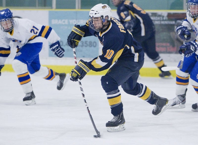 Thomas Foster of the St. Albert Raiders looks to make a pass in Sunday&#8217;s 8-2 win over the Calgary Royals at Akinsdale Arena. The Raiders skate into the Mac&#8217;s
