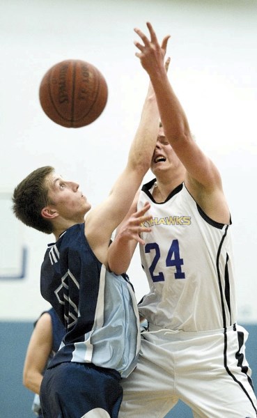 Tyler Wise (left) of the Paul Kane Blues and Cole Aikens of the St. Albert Skyhawks collide while going for the ball in the first half of Wednesday&#8217;s Metro Edmonton