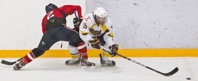 STRETCH PLAY – Sebastian Auray of the St. Albert Raiders reaches for the puck while checked by Holden Daley of the Canadian Athletic Club on Dec. 23 in the last game for the