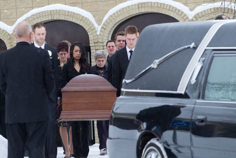 TRAGIC LOSS – Chris Rogers&#8217; family members escort his casket following his funeral service at Holy Family Catholic Church in St. Albert.