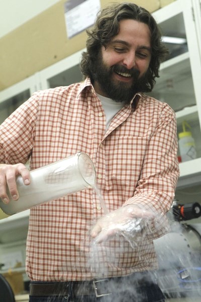 FUN WITH SCIENCE – University of Alberta physicist John Davis pours liquid nitrogen over his hand at his lab in Edmonton. Despite being -196 C