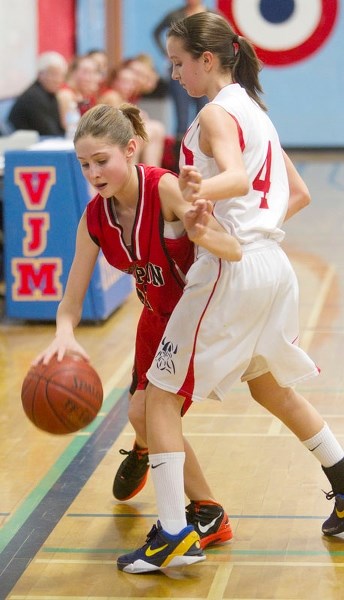 RUNNING OUT OF ROOM &#8211; Sierra Gaulden of the Sir George Simpson Voyageurs tries to dribble down the sideline past Marina Cain of the Vincent J. Maloney Marauders in