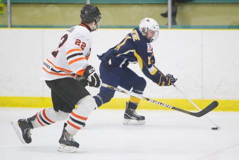 HOME ICE EDGE &#8211; Brett Smythe of the St. Albert Raiders skates away from Cole Nicholson of the Lloydminster Bobcats in a recent midget AAA game at Akinsdale Arena. The