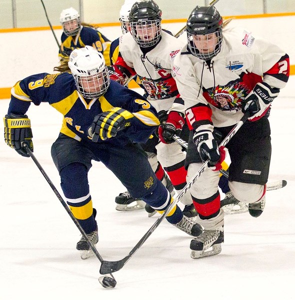 PUCK CHASERS &#8211; Autumn Rae of the St. Albert Slash and Katlynn Kyle of the Red Deer Chiefs skate after the puck in the Alberta Major Midget Female Hockey League game
